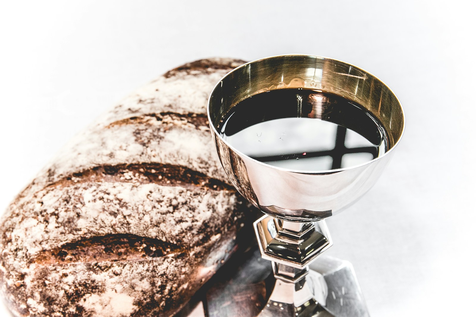 Bread beside a chalice of wine, symbolising Holy Communion